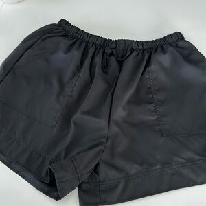 Black Pull on Shorts with tie string to tighten. Side pockets and back pockets.